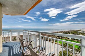 Enjoy the ocean view from this balcony with a clear view of the beach and surrounding landscape.