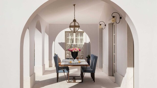 A dining area with a table, chairs, a chandelier, and a vase of flowers. - Villa Palazzo di Cleo with Pool (Vabriga)