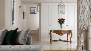 A living room with a grey sofa, a wooden coffee table, and a white wardrobe. - Villa Palazzo di Cleo with Pool (Vabriga)