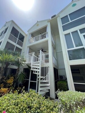 A multi-story building with balconies and a central spiral staircase. - PARADISE FOUND! (Key Largo, FL 33037)