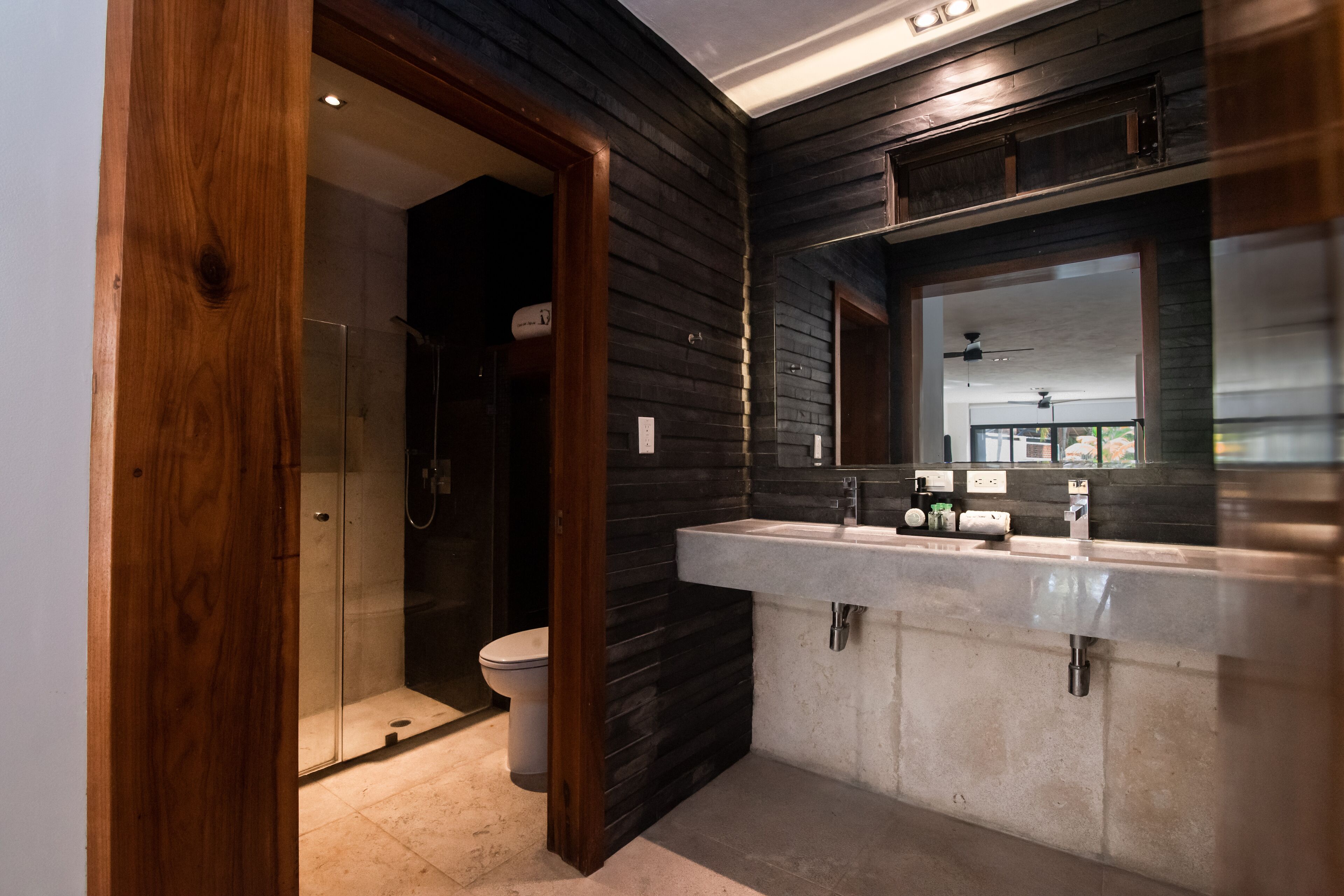 deluxe suite | bathroom | shower, rainfall showerhead, designer toiletries, hair dryer