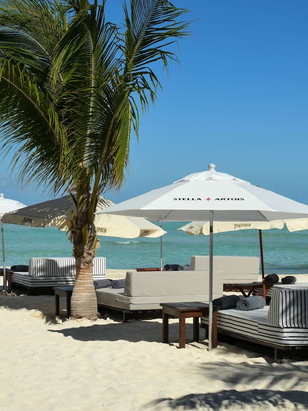 On the beach, white sand, sun loungers, beach umbrellas