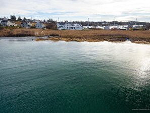 A coastal residential area with houses near a body of water.