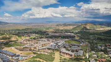 Un complexe hôtelier comprenant plusieurs bâtiments, une piscine et un paysage montagneux en toile de fond.