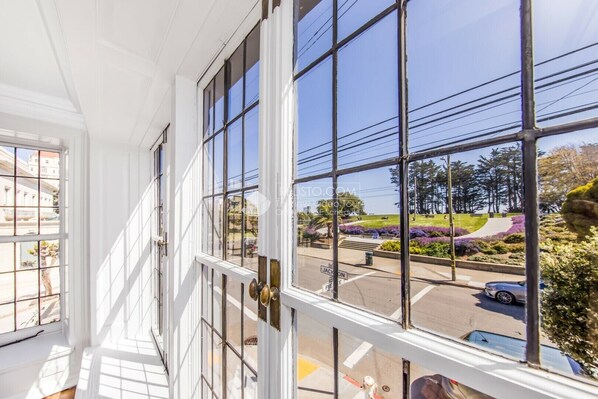 Enjoy a view of the street below from the large window with multiple panes.