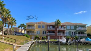 A marina with boats docked, a wooden walkway, and multi-story buildings with balconies. - Town home in the Marina  38 HT (Laguna Vista)