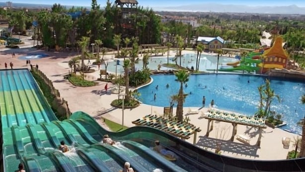 A water park with multiple slides and a large pool area.