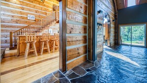 A wooden interior with a staircase leading to a dining area. - Large Grand Bend Getaway. Swim, Golf, Relax (South Huron (Munic))