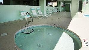 A swimming pool with lounge chairs and a diving board. - Welcome to PARADISE POINTE, your ultimate oceanfront retreat in North Myrtle Beach (North Myrtle Beach)