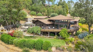 A modern two-story house with a deck, surrounded by lush greenery and trees. - Escape to “Casa Paradiso” in the Napa Valley! (Calistoga)