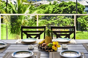 Enjoy a romantic dinner for two on the outdoor terrace with a serene view of lush greenery.
