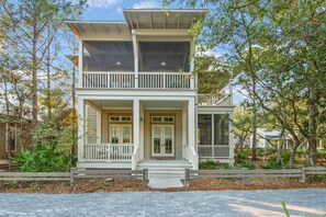 A two-story house with a balcony, a front porch, and a garage.