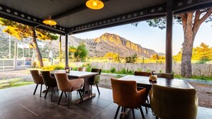 An outdoor dining area with a view of a mountain.