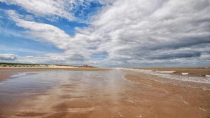 A beach with a wide sandy shore and a clear sky with scattered clouds. - The Sidings, Docking, Norfolk (Docking)