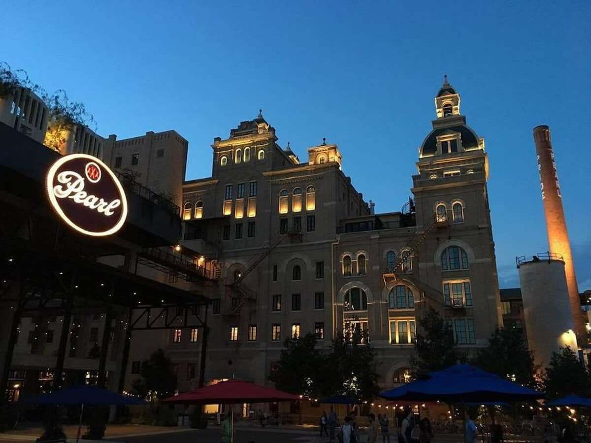 A historic building with a prominent clock tower and a large illuminated sign.