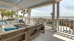A covered outdoor seating area with a view of the beach. - 🌅Coastal Sunrise🌅Ocean Front on Ocean Blvd. Private Pool/hot tub, stunning ocean views! (Isle Of Palms)