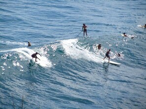 Guests can enjoy water sports like surfing and paddleboarding in the nearby waters.