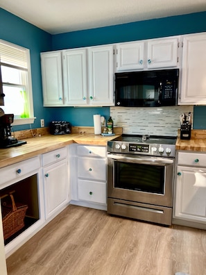 Full kitchen w new counters, added storage, generous pantry and ocean views 