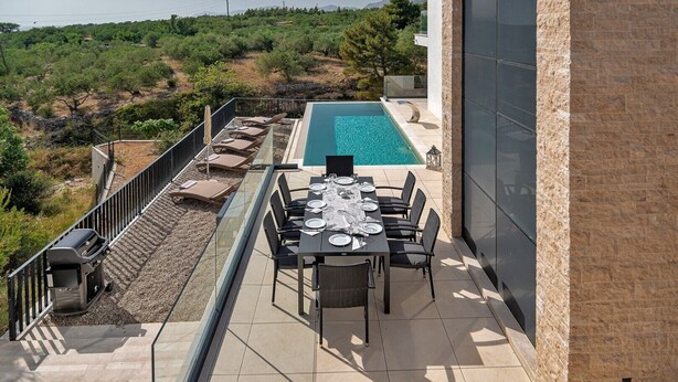 A rooftop terrace with a pool, dining area, and outdoor seating. - Villa Sea Splendor with Pool (Promajna)