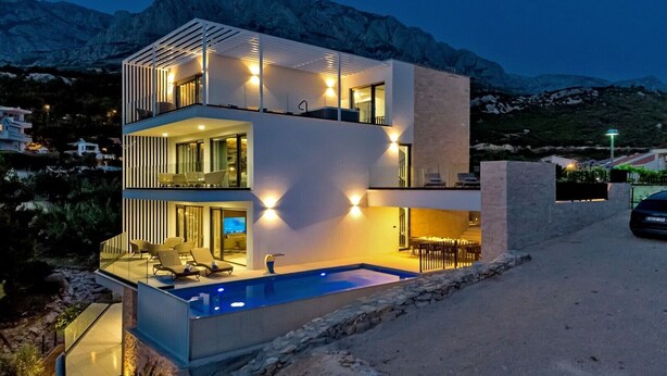 A modern two-story house with a pool, featuring a balcony with outdoor seating and a view of the mountains. - Villa Sea Crystal with Pool (Promajna)