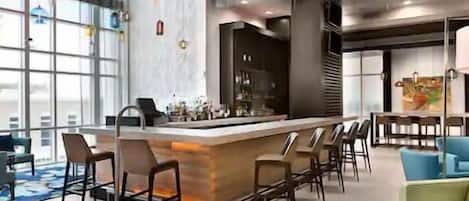 Enjoy a drink at the centrally located bar with comfortable seating for all.