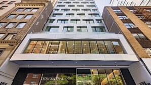 A modern building with a glass facade, labeled 'The Central 5th' and 'Hilton Club.' - NYC | 5th Ave Location | Central Park | 1BR Penthouse (New York)