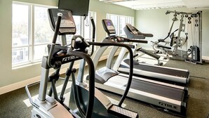 A gym with treadmills, ellipticals, and weight machines.
