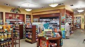 A pharmacy with various products on shelves and a central display. - Waikiki | Waikiki Lagoon Escape | Pool & Beach | 1BR (Honolulu)