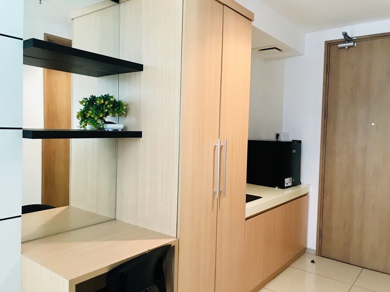 A modern bedroom with a bed, a bedside table, and a wardrobe.