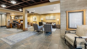 A spacious lobby with a high ceiling, a reception desk, seating area, and a wall-mounted map. - Amazing Unit!  Sleeps 5. Swim or Ski out your front door. On site at Silver Mt. (Kellogg)