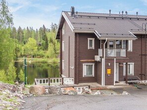 A wooden lodge with a balcony, a sign reading 'RANTATUPA', and a view of a lake. - Tahkon rantatupa 7 b by Interhome (Nilsiä)