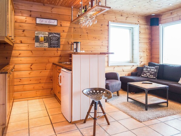 A cozy cabin interior with a kitchen, a dining area, and a living room. - Tahkon rantatupa 7 b by Interhome (Nilsiä)