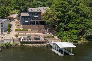 A multi-story house with a dock, outdoor seating, and a pool area. - Viewhouse 24 - Five Bedroom House, Sleeps 12 (Sunrise Beach)