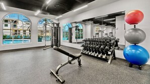 A gym with exercise equipment, a bench, and a rack of dumbbells. - Luxury 3BD Calypso Gulf Views! Free Beach Chairs Service for 4 (Panama City Beach)