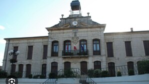 A historic building with a clock tower, multiple windows, and flags. - Magnificent new villa with swimming pool 6 travellers (Valros)