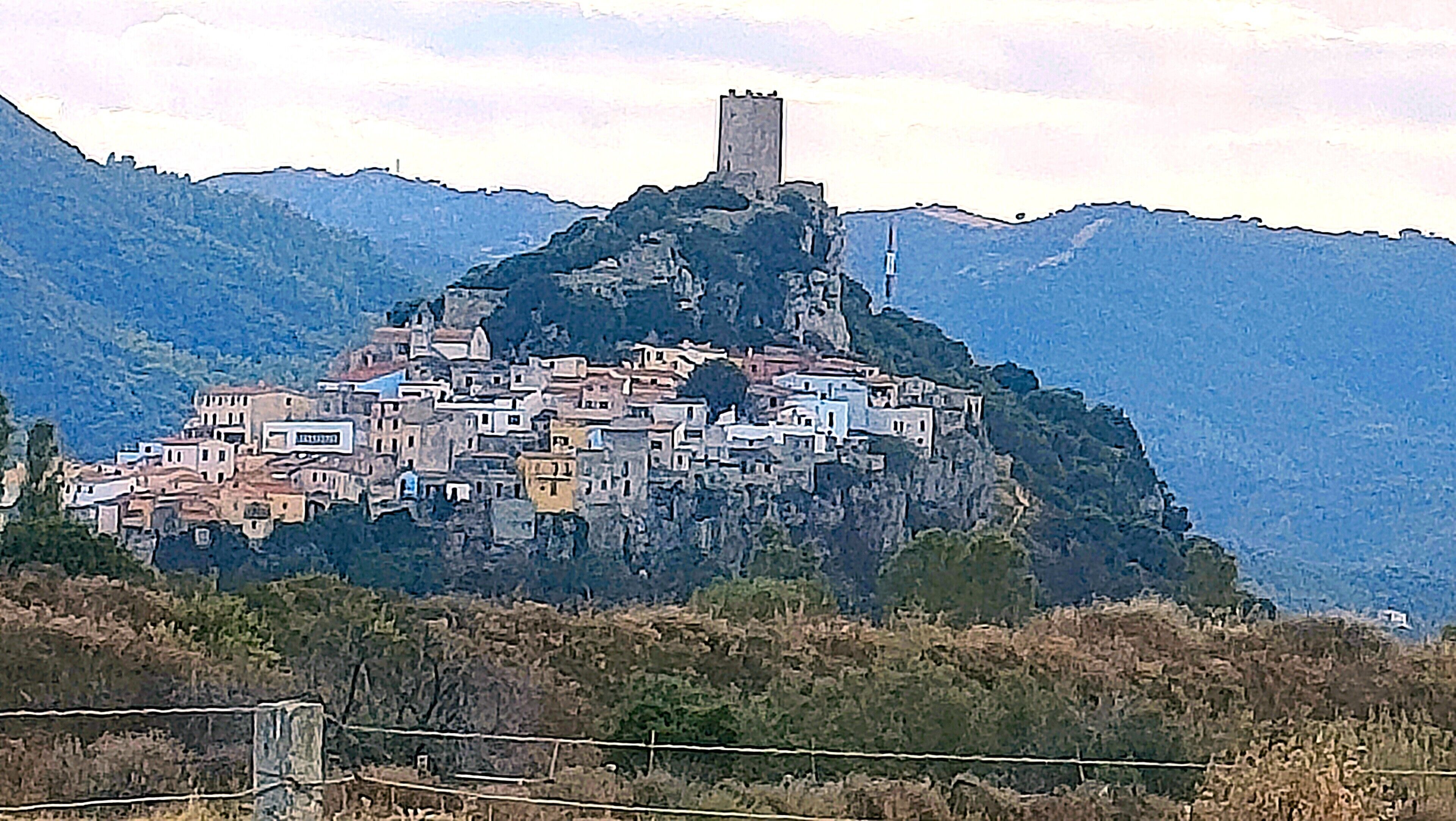 A town built on a hill with a prominent tower.