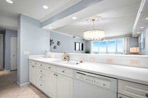 Fridge, microwave, coffee/tea maker, cookware/dishes/utensils