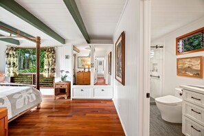 Cozy retreat with a bed, bathroom, and natural light.