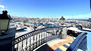 A marina with boats docked, a railing, and a lamp post. - Home2Book Sea Front Attic Las Galletas (Costa del Silencio)
