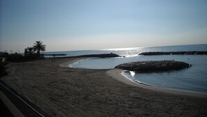 A beach with clear skies, calm water, and a sandy shore. - Casa il Ciliegio (Terzorio)