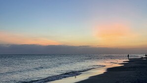 A beach with a clear sky and calm sea.