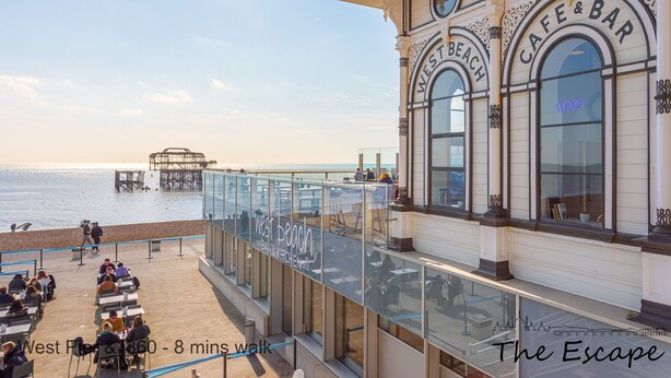 A waterfront cafe with outdoor seating overlooking the sea. - The Escape (Brighton)
