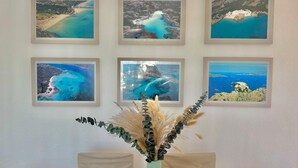 A wall with six framed aerial photographs of coastal landscapes.