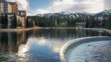 A hotel with a view of a lake and mountains.