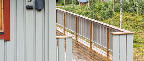 A wooden deck leading to a building with a number '9' sign.