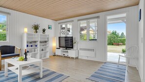 A modern living room with a white interior, wooden ceiling, and large windows. - 2 bedroom amazing home in Skibby (Skibby)