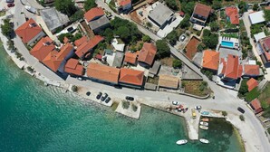 An aerial view of a coastal residential area with houses, a dock, and boats. - Awesome home in Vinisce (Vinisce)