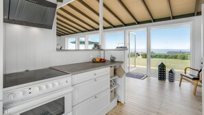 A modern kitchen with a large window, a built-in oven, and a view of the countryside. - Amazing home in Slagelse with WiFi (Slagelse)