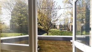 A view from a window with a brick wall and a grassy yard. - Moorish Castle (Newcastle-upon-Tyne)