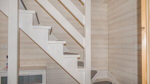 A staircase with white railings and wooden steps, leading to a lower level. - Pet friendly home in Rewal with WiFi (Rewal)